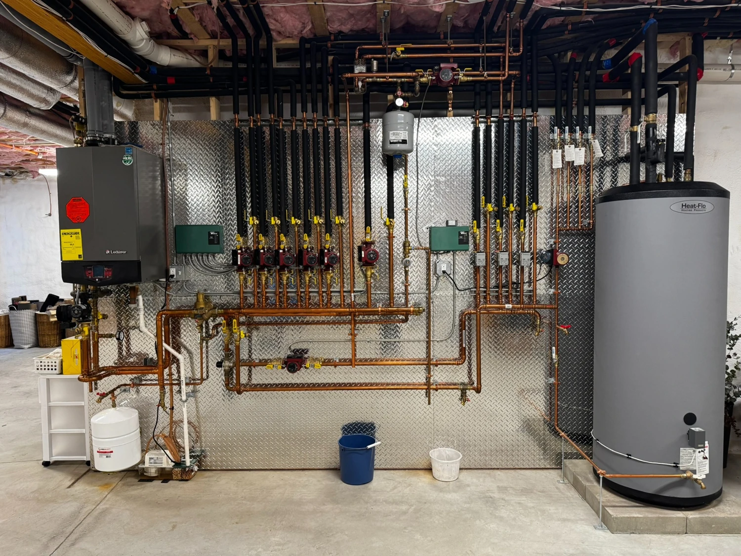 Boiler, water heater and a wall of insulated heating piping
