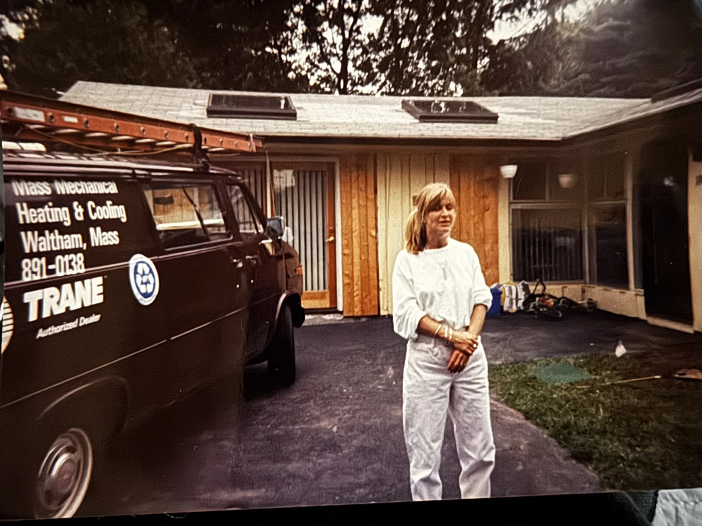 Aaron Emberley’s mother beside an early Mass Mechanical service van