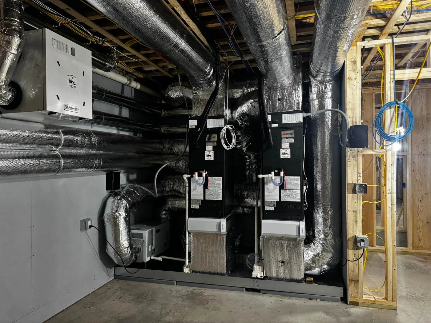 Two air handlers with extensive insulated ductwork in a home under construction