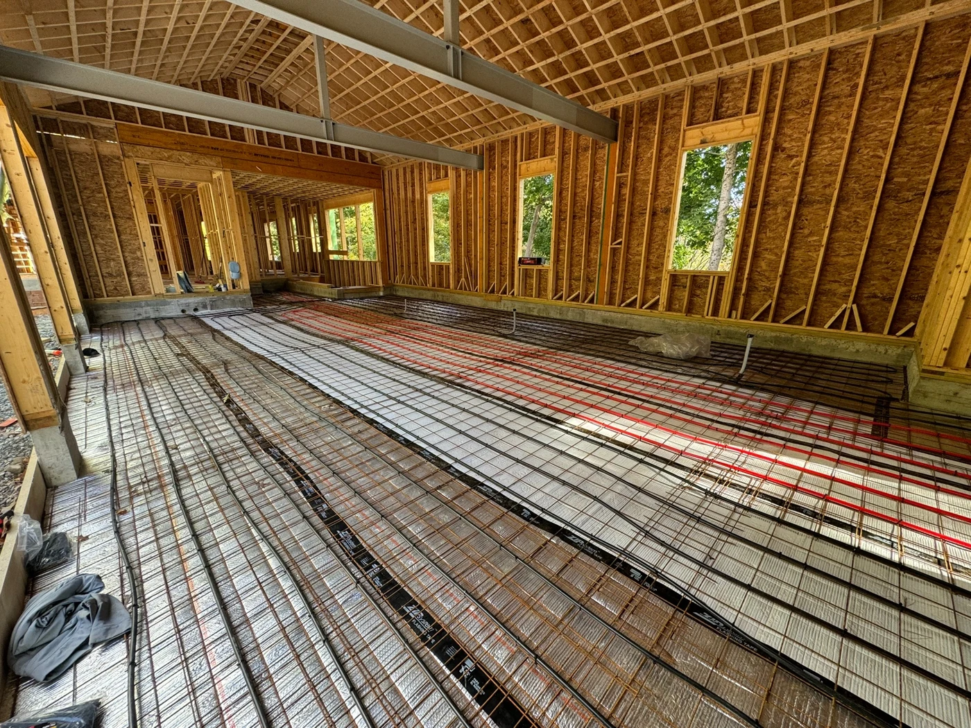 Radiant heating tubing laid across the floor of a new home under construction